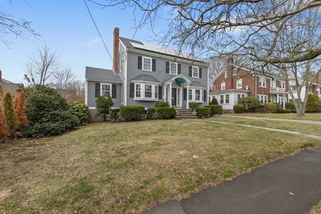 10 Standish Road Milton, MA 02186 - Photo 1 of 28 a front view of residential houses with yard and trees