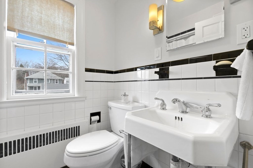 10 Standish Road Milton, MA 02186 - Photo 16 of 28 a white toilet sitting next to a bathroom sink