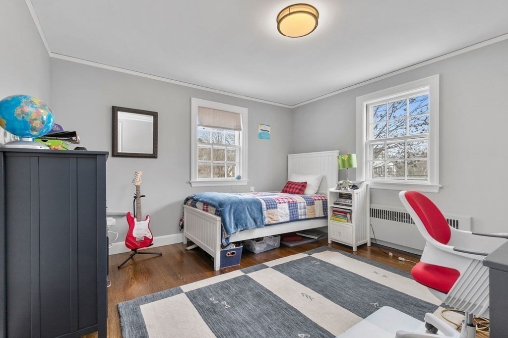 10 Standish Road Milton, MA 02186 - Photo 17 of 28 a bedroom with a bed and wooden floor