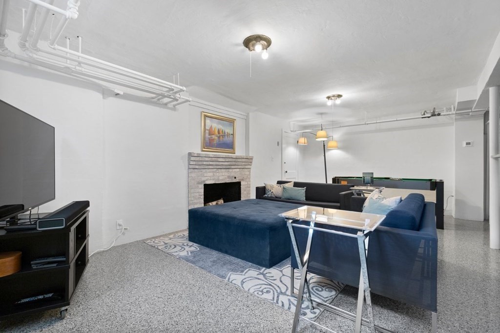 10 Standish Road Milton, MA 02186 - Photo 20 of 28 a view of a livingroom with furniture and a fireplace