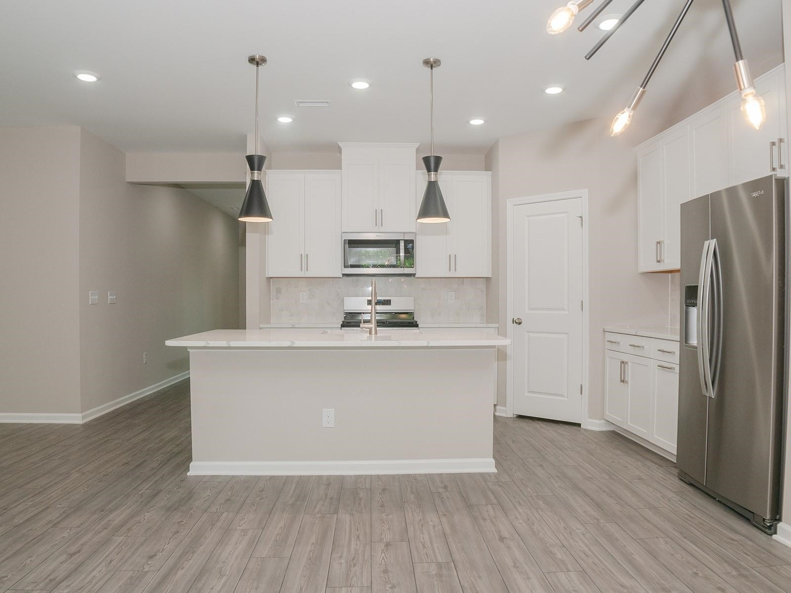 4001 Mountjoy Trail Raleigh, NC 27616 - Photo 15 of 59 a view of kitchen with stainless steel appliances granite countertop a stove a sink a refrigerator and a island with wooden floor