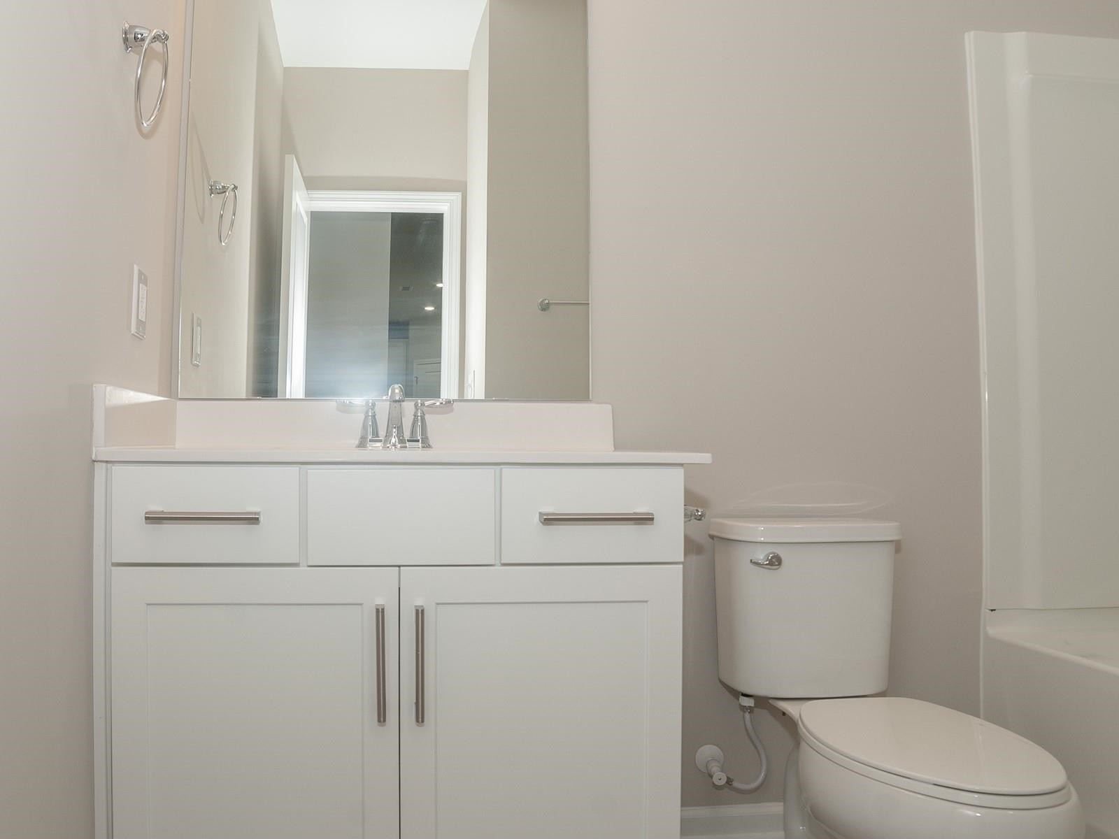 4001 Mountjoy Trail Raleigh, NC 27616 - Photo 25 of 59 a bathroom with a toilet sink vanity and mirror