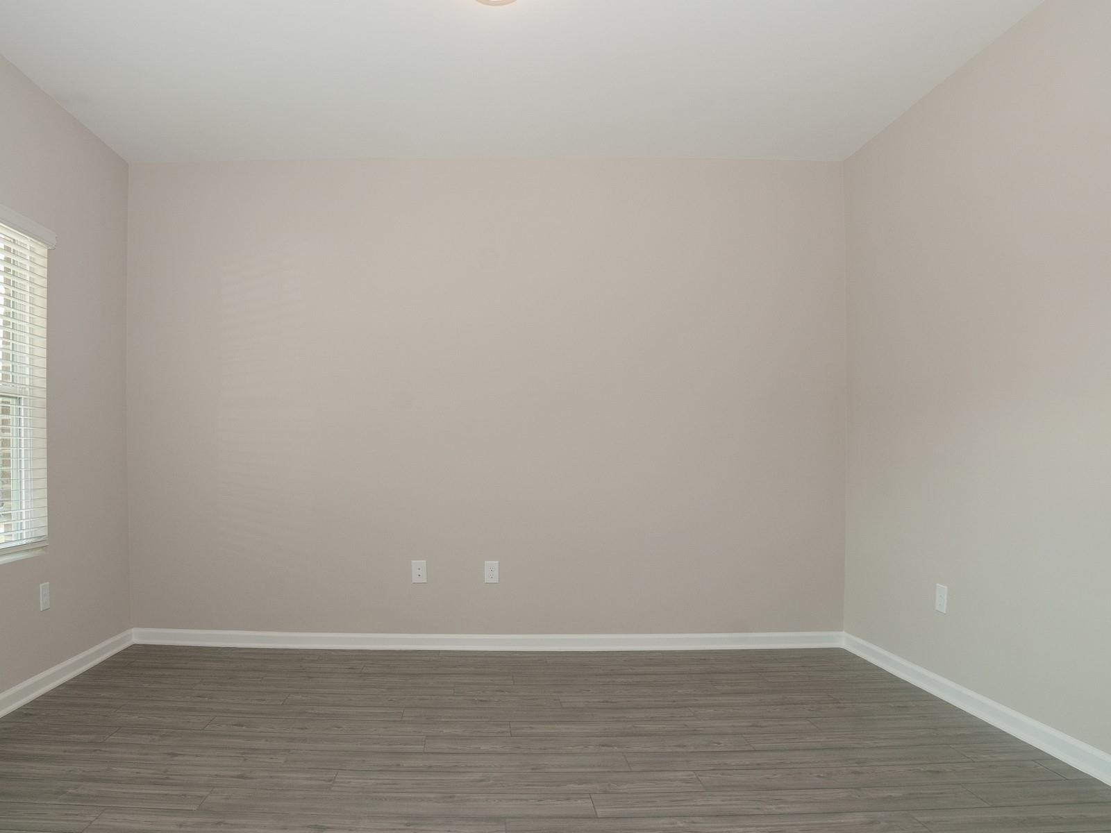 4001 Mountjoy Trail Raleigh, NC 27616 - Photo 5 of 59 a view of an empty room with wooden floor and a window