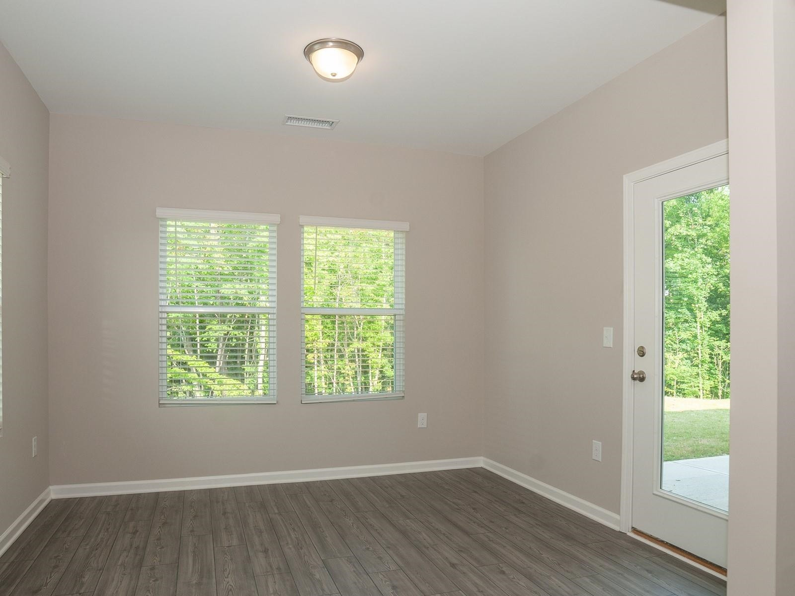 4001 Mountjoy Trail Raleigh, NC 27616 - Photo 7 of 59 an empty room with wooden floor and windows