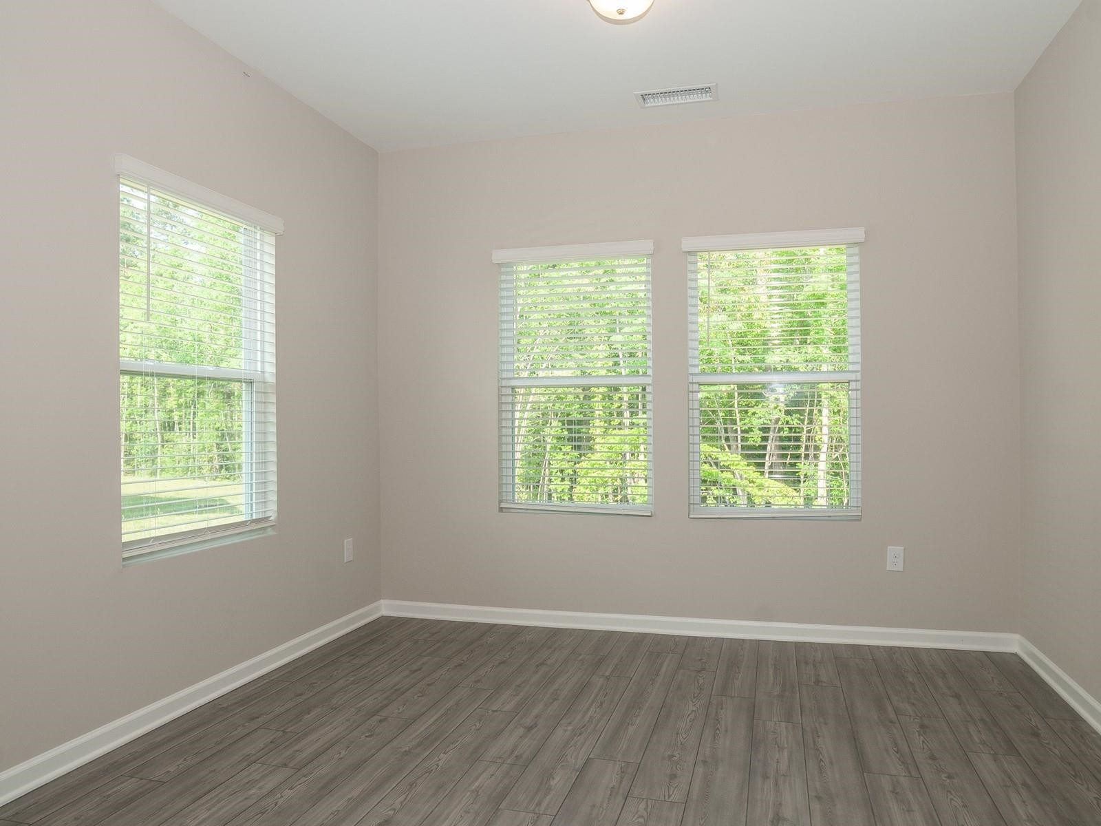 4001 Mountjoy Trail Raleigh, NC 27616 - Photo 8 of 59 an empty room with wooden floor and windows