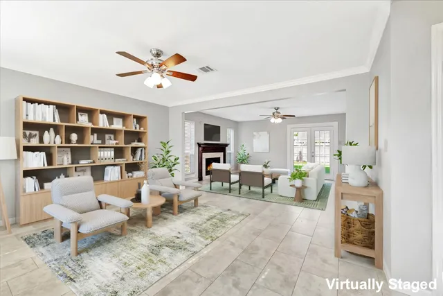 a living room with furniture and a book shelf