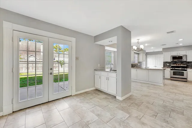 a view of a kitchen with a sink and a large window