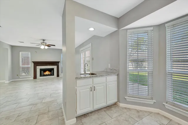 a view of an empty room with a fireplace and a window