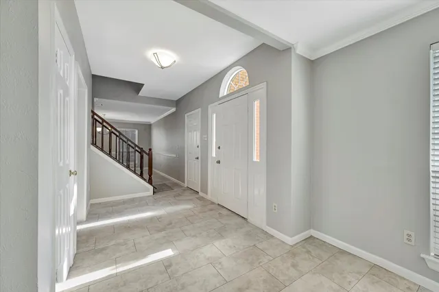 a view of hallway with stairs and a window