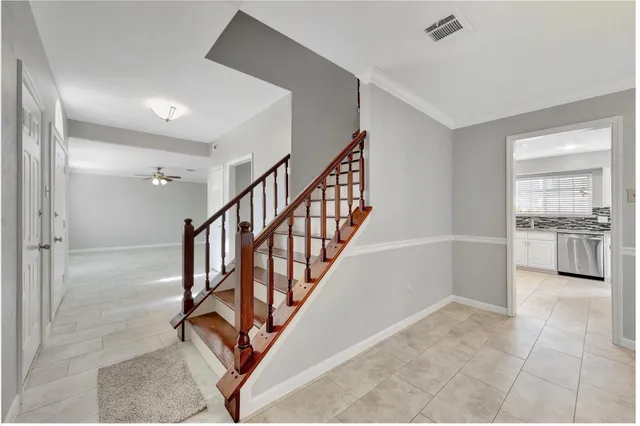a view of a hallway to an entryway with kitchen