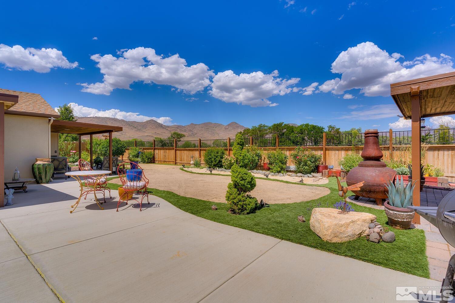 148 Carson River Drive Dayton, NV 89403 - Photo 13 of 31 a view of a patio with table and chairs potted plants and large tree