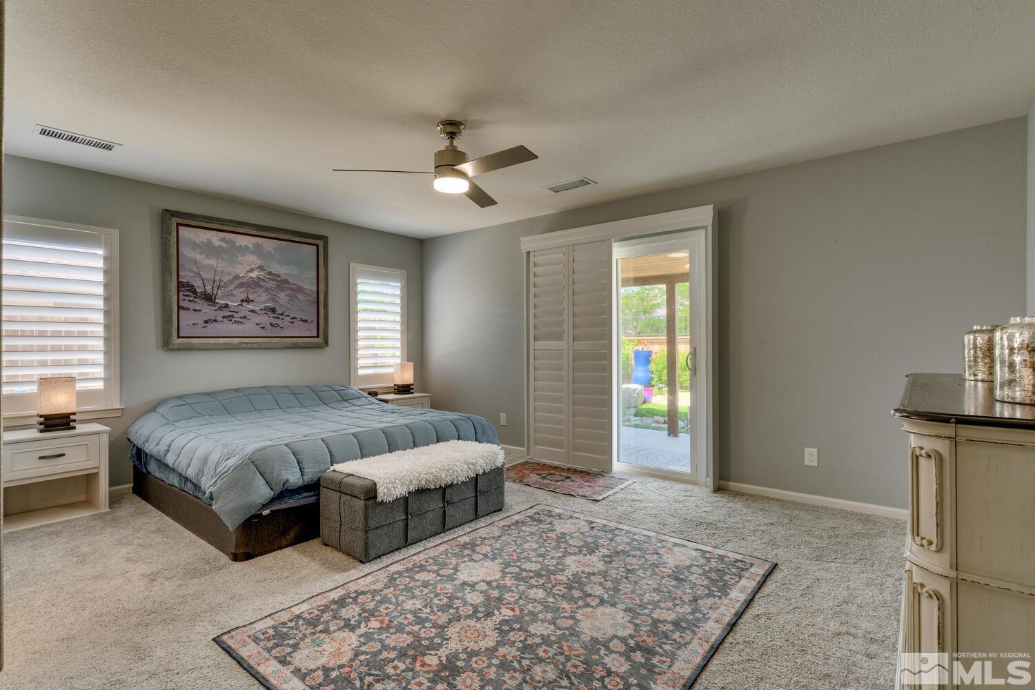 148 Carson River Drive Dayton, NV 89403 - Photo 19 of 31 a spacious bedroom with a bed and a chandelier
