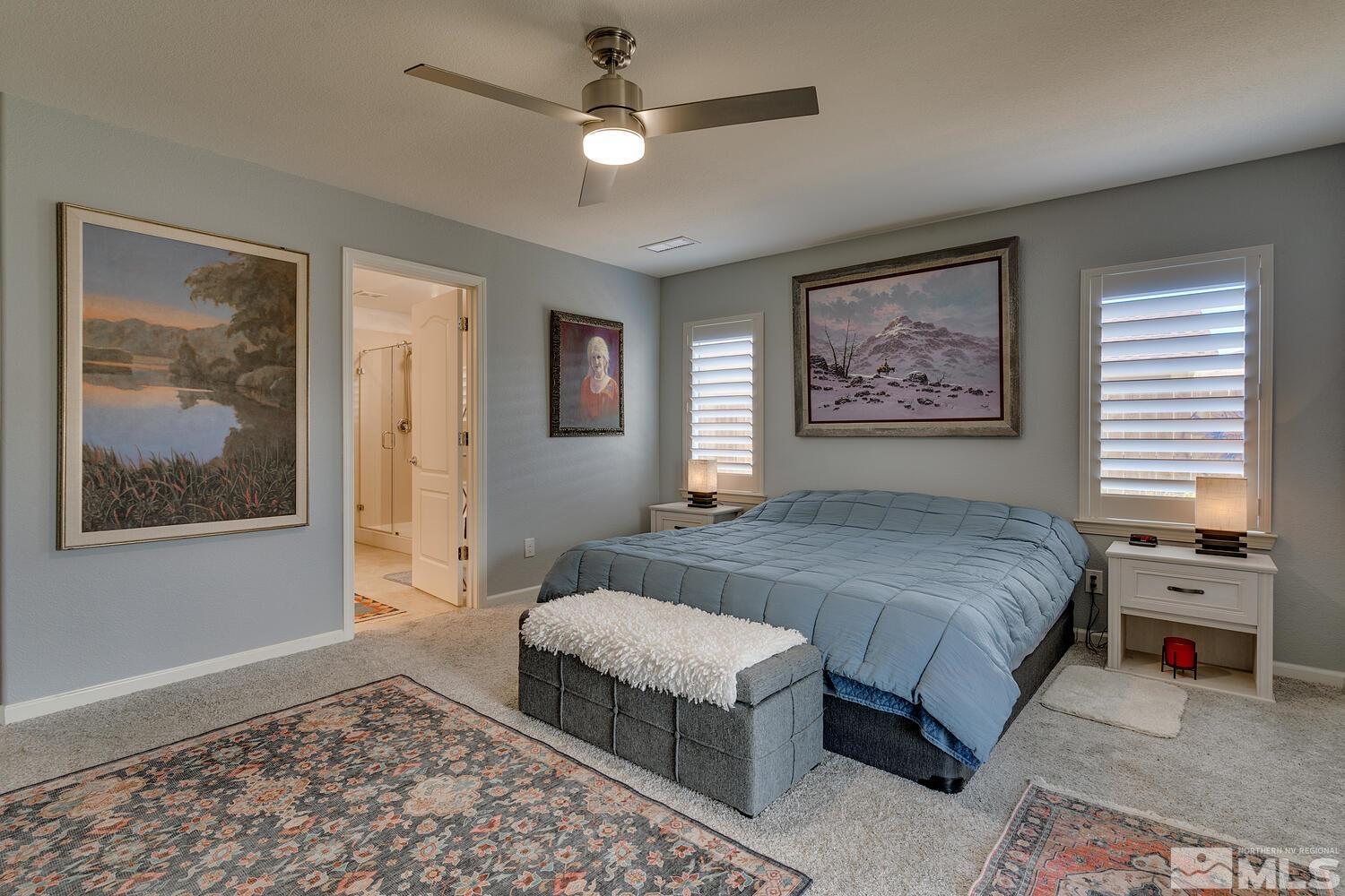 148 Carson River Drive Dayton, NV 89403 - Photo 20 of 31 a spacious bedroom with a bed and a painting on the wall