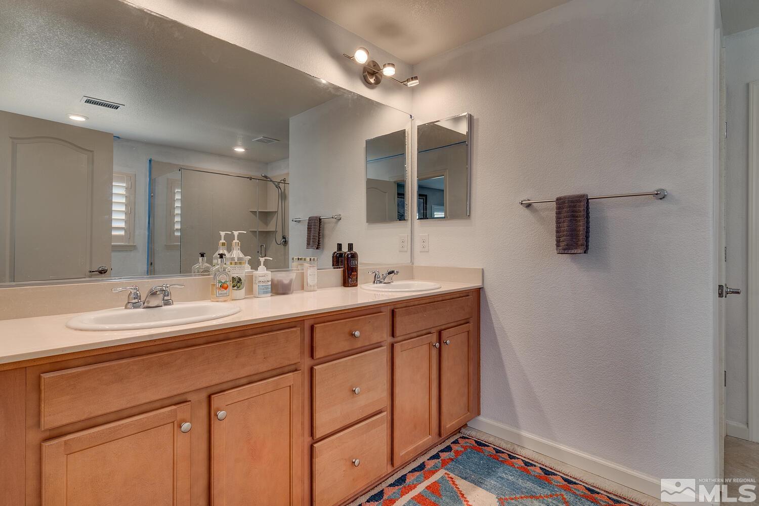 148 Carson River Drive Dayton, NV 89403 - Photo 21 of 31 a bathroom with a sink a vanity and mirror