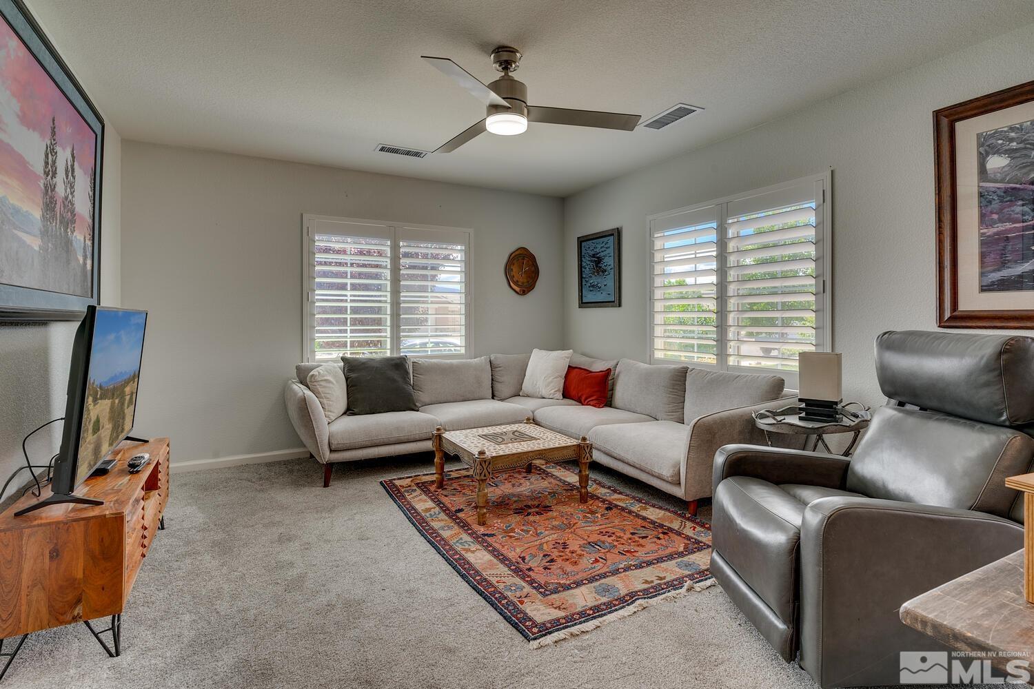 148 Carson River Drive Dayton, NV 89403 - Photo 27 of 31 a living room with furniture a window and a flat screen tv