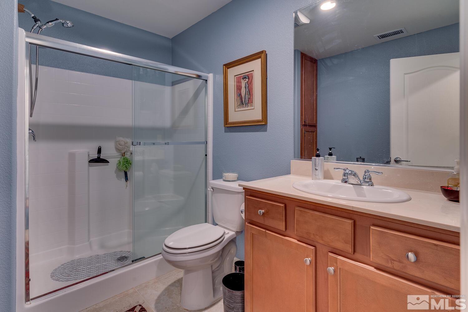 148 Carson River Drive Dayton, NV 89403 - Photo 30 of 31 a bathroom with a sink a toilet and shower