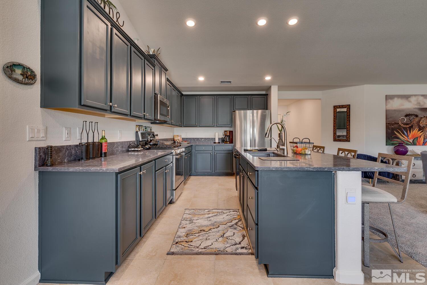 148 Carson River Drive Dayton, NV 89403 - Photo 8 of 31 a kitchen with stainless steel appliances granite countertop a refrigerator stove microwave and sink