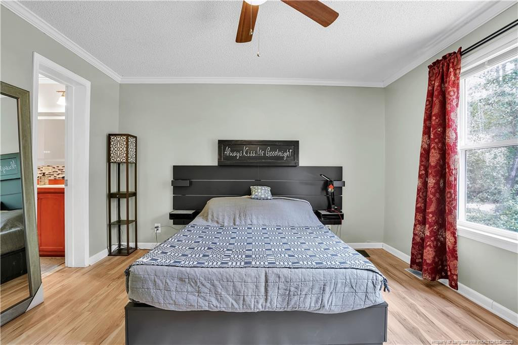 8155 Arabia Road Lumber Bridge, NC 28357 - Photo 21 of 30 a bedroom with a large bed and a large window