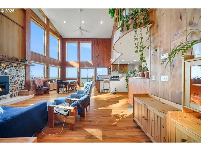 a living room with fireplace furniture and a large window