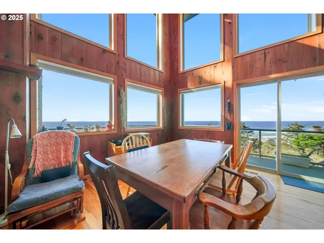 a dining room with furniture window and wooden floor