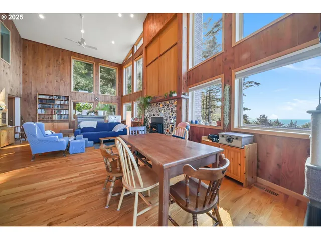 a dining room with furniture a rug and wooden floor