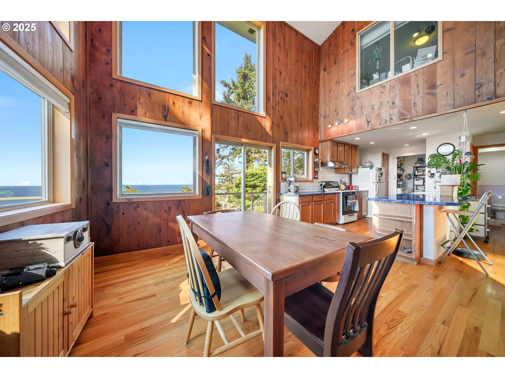 674 Pacific View Drive Yachats, OR 97498 - Photo 19 of 47 a view of a dining table and chairs in a kitchen