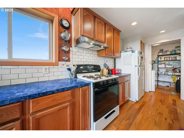 a kitchen with sink and a wooden floor