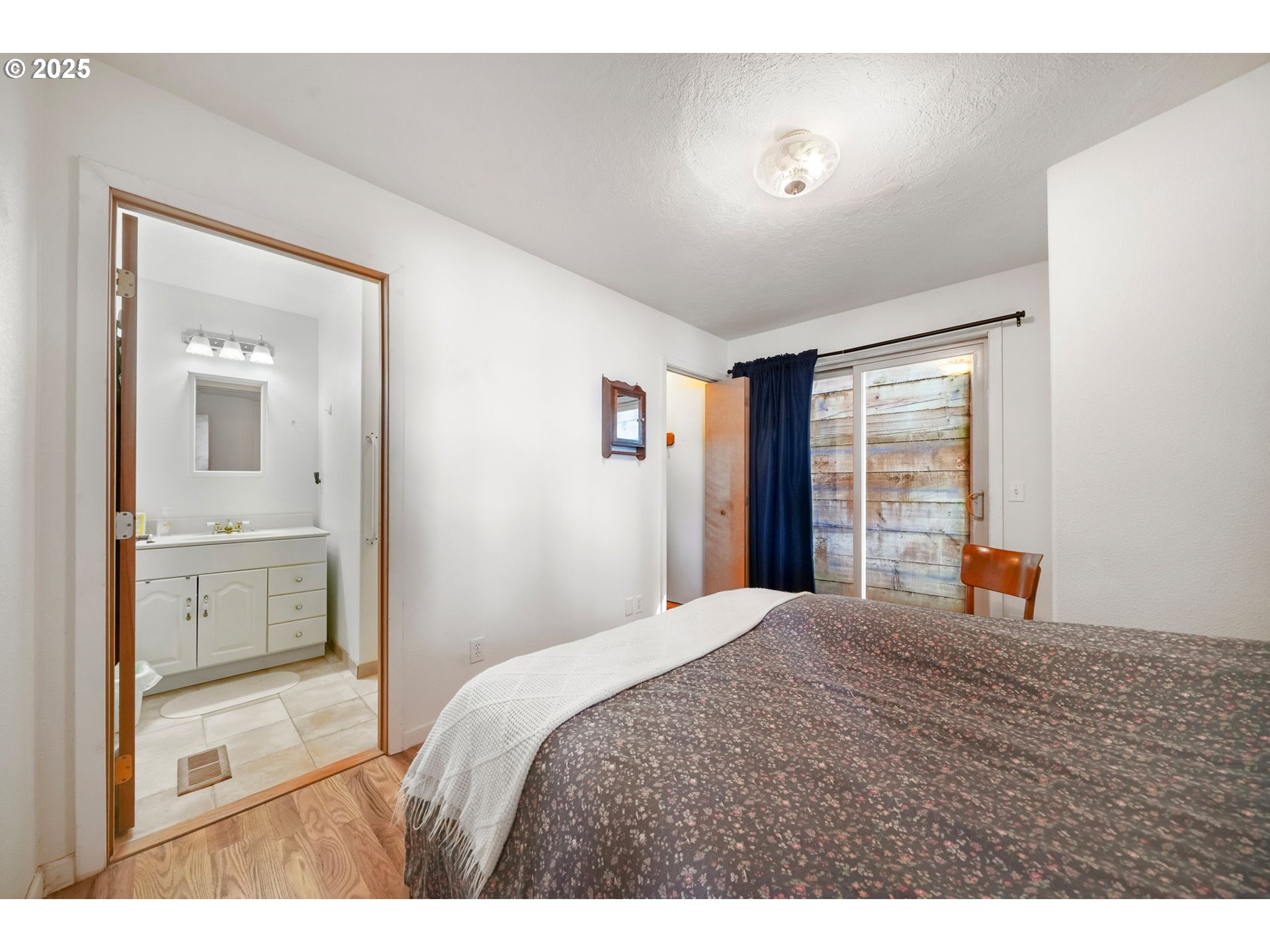 674 Pacific View Drive Yachats, OR 97498 - Photo 28 of 47 a bedroom with a bed and a large window