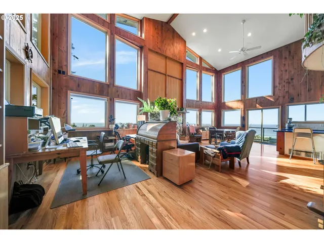 a living room with fireplace furniture and a large window