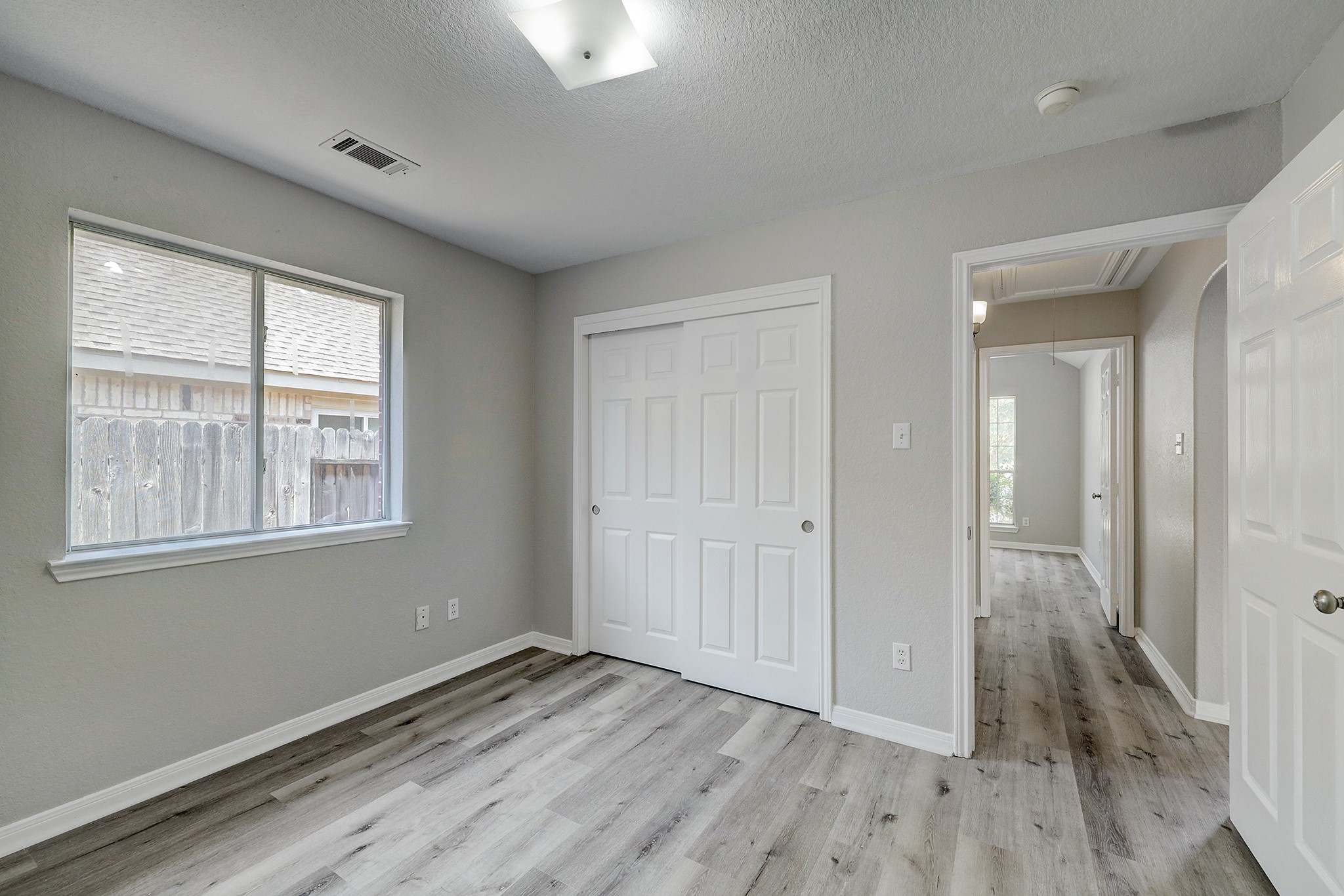 24031 Holleygate Court Spring, TX 77373 - Photo 13 of 17 a view of an empty room with wooden floor and a window