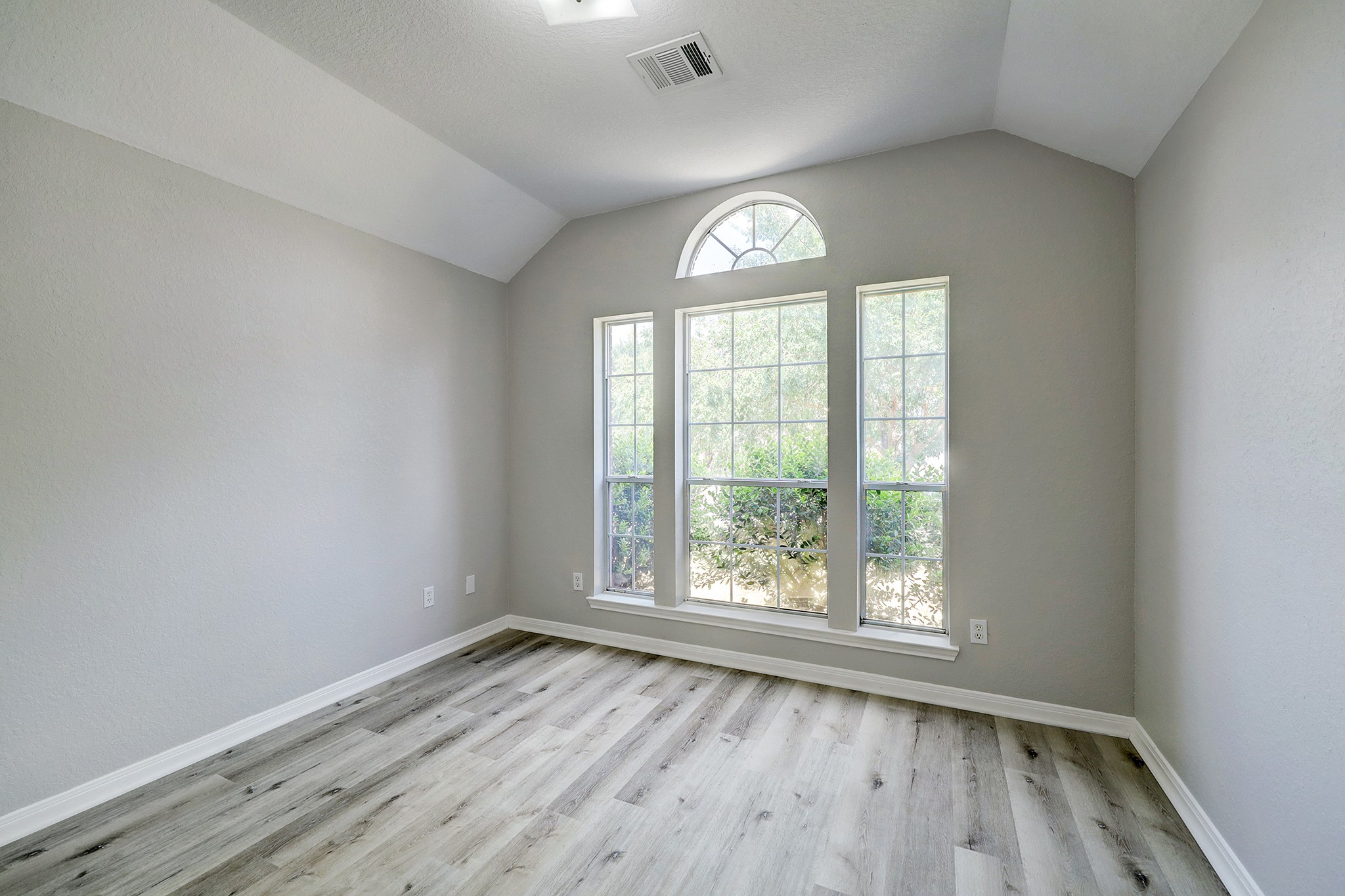 24031 Holleygate Court Spring, TX 77373 - Photo 15 of 17 an empty room with wooden floor and windows
