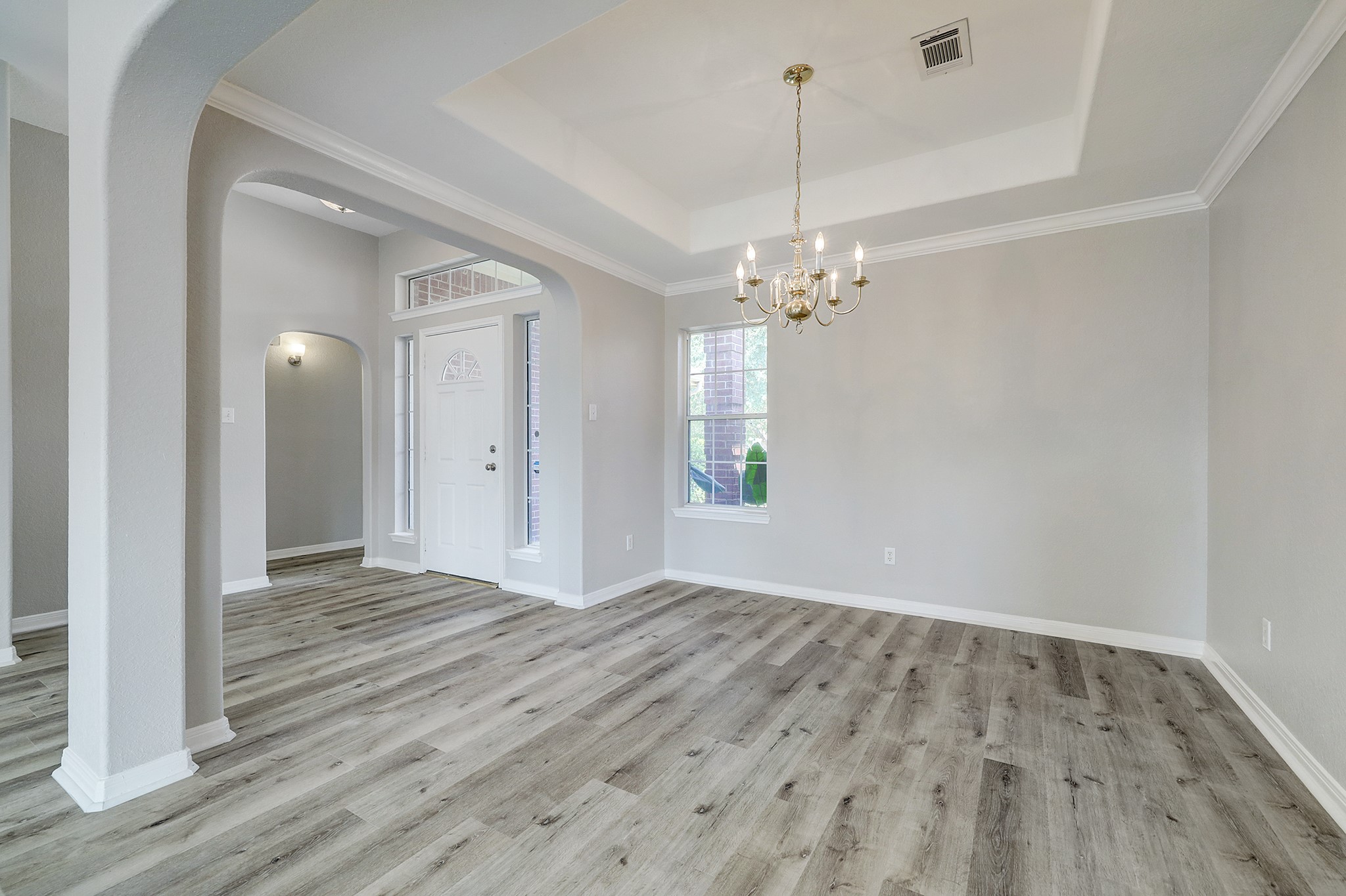 24031 Holleygate Court Spring, TX 77373 - Photo 4 of 17 a view of a hallway with wooden floor and a chandelier