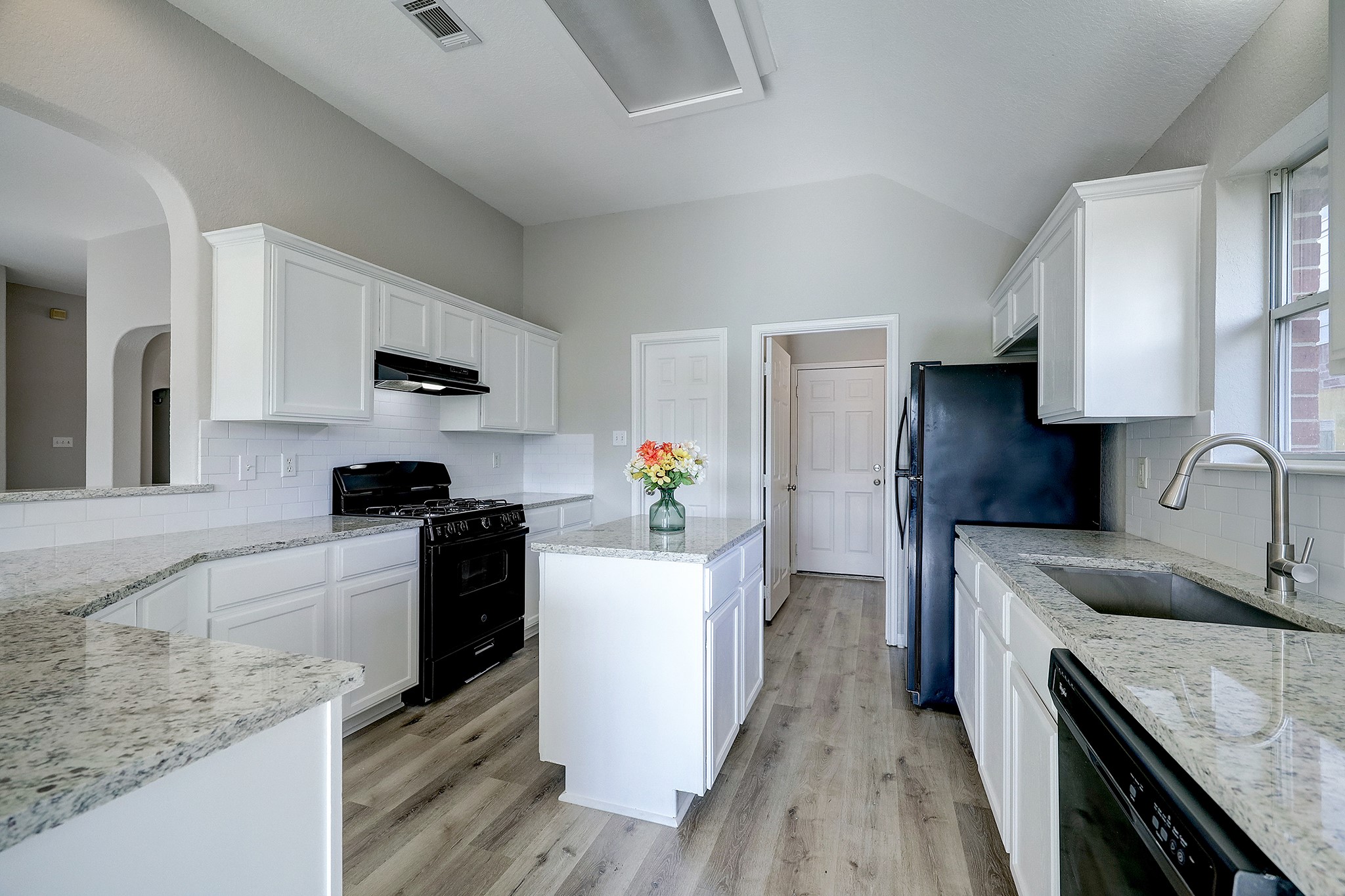 24031 Holleygate Court Spring, TX 77373 - Photo 8 of 17 a kitchen with a sink stove and refrigerator