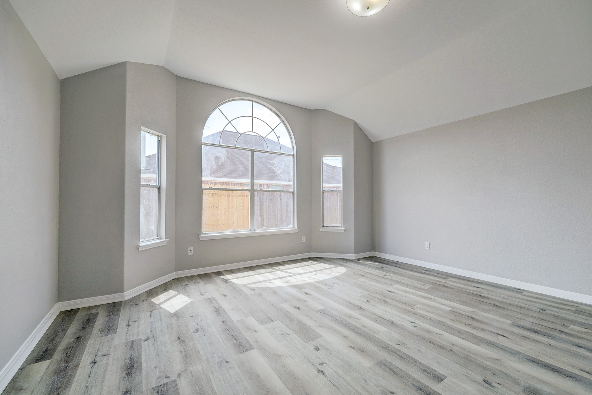 24031 Holleygate Court Spring, TX 77373 - Photo 10 of 17 an empty room with wooden floor and windows