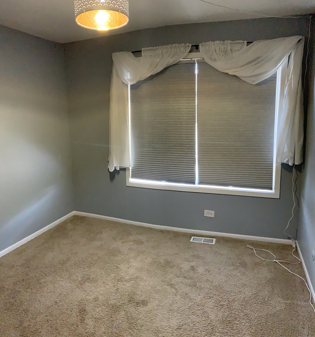 7 Red Barn Road, Unit 107 Matteson, IL 60443 - Photo 11 of 15 a view of an empty room with a window