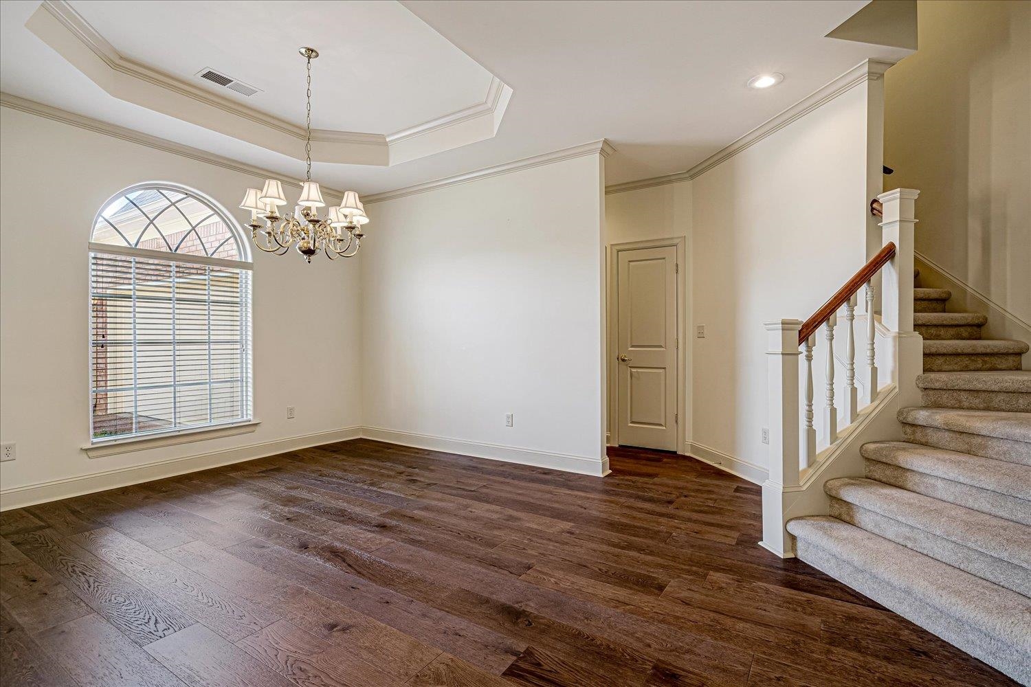 9178 Wilderridge Lane Memphis, TN 38018 - Photo 12 of 31 an empty room with wooden floor chandelier and entryway