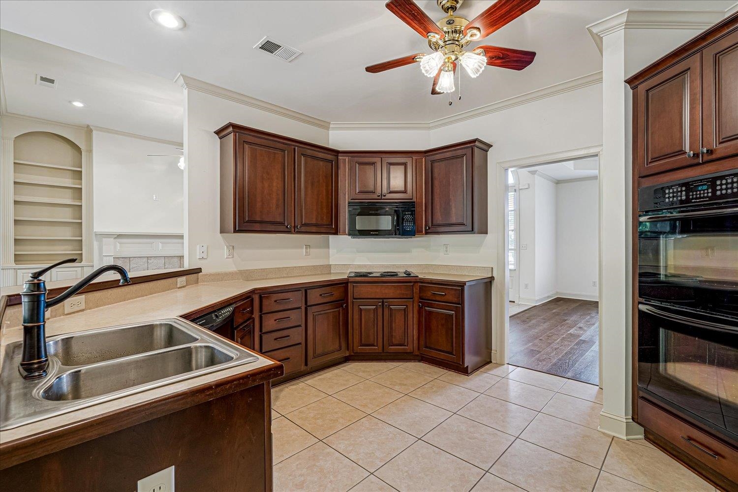 9178 Wilderridge Lane Memphis, TN 38018 - Photo 16 of 31 a kitchen with stainless steel appliances granite countertop a sink and dishwasher a stove top oven with wooden floor