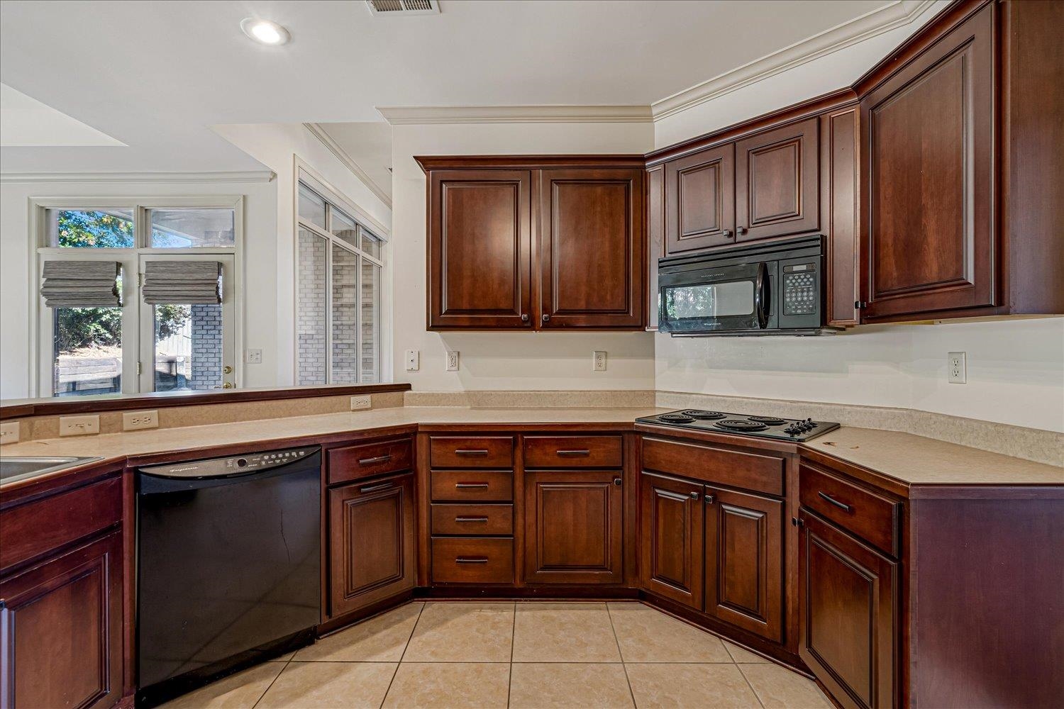 9178 Wilderridge Lane Memphis, TN 38018 - Photo 17 of 31 a kitchen with stainless steel appliances granite countertop wooden cabinets a sink and dishwasher