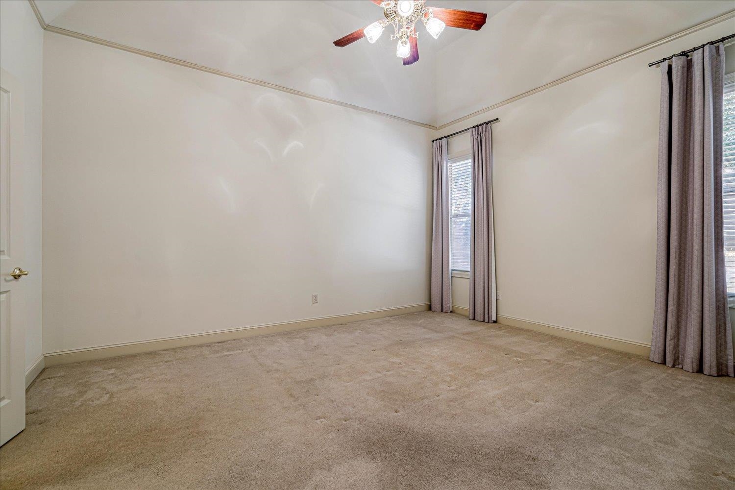 9178 Wilderridge Lane Memphis, TN 38018 - Photo 20 of 31 an empty room with a chandelier fan and windows