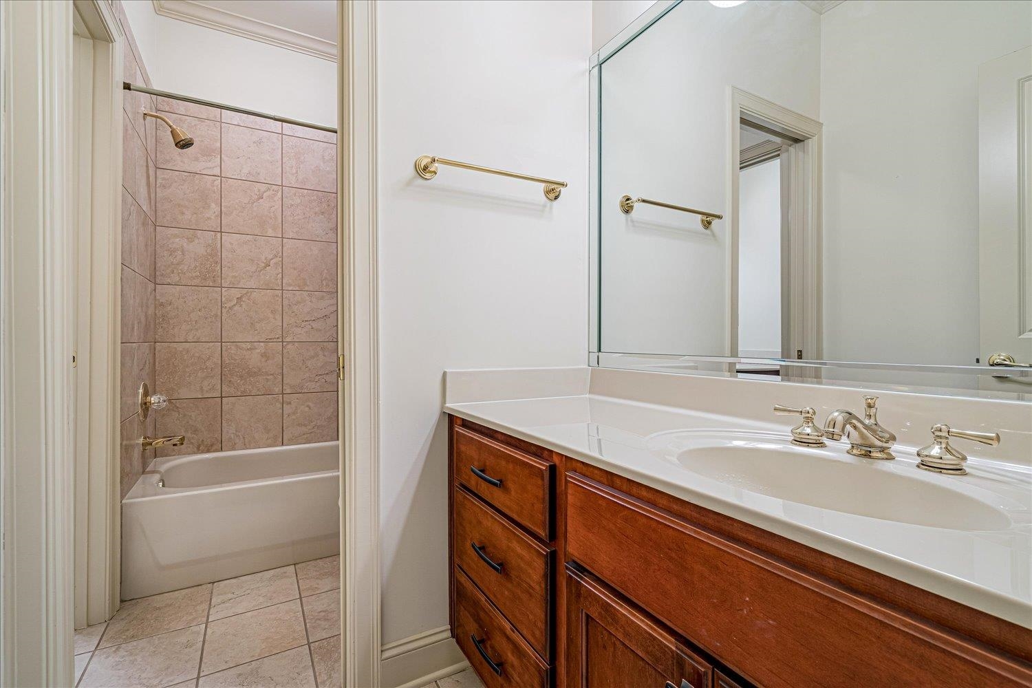 9178 Wilderridge Lane Memphis, TN 38018 - Photo 25 of 31 a bathroom with a granite countertop sink a mirror and a bathtub