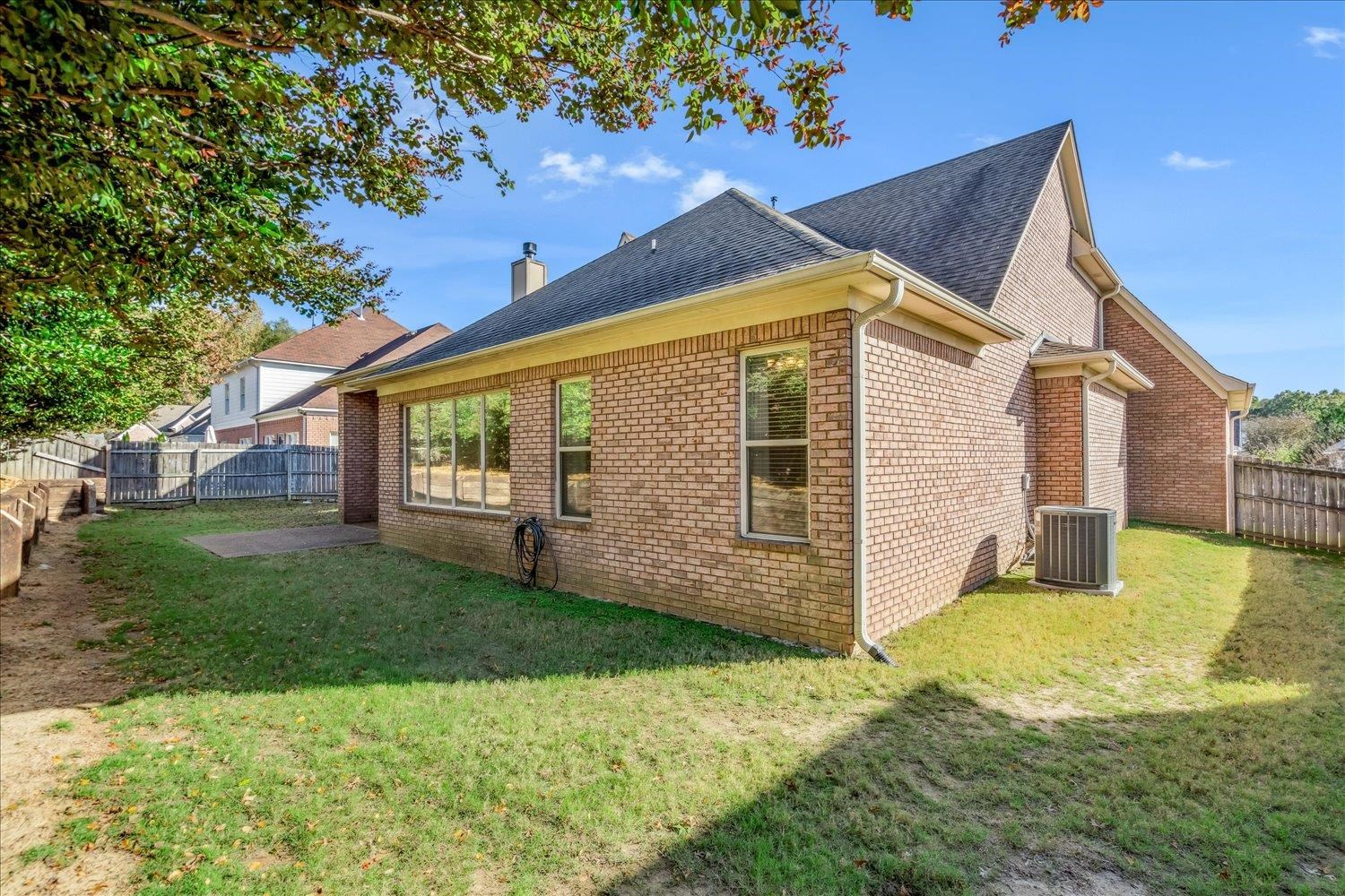 9178 Wilderridge Lane Memphis, TN 38018 - Photo 30 of 31 a view of a house with backyard and a tree