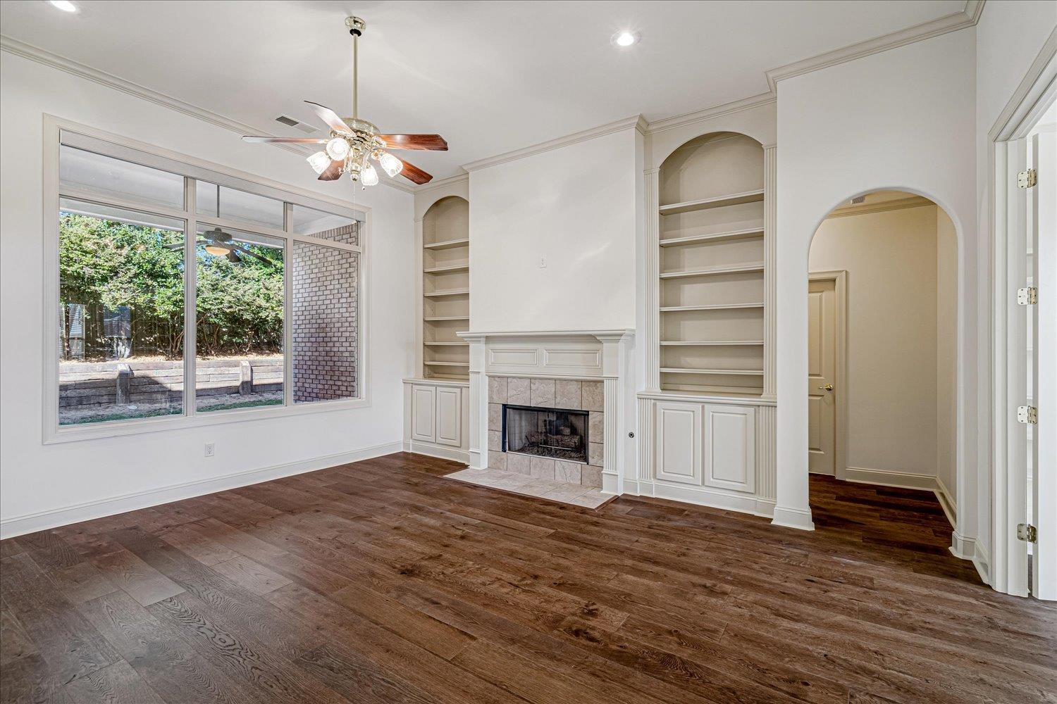 9178 Wilderridge Lane Memphis, TN 38018 - Photo 5 of 31 a view of a livingroom with wooden floor a fireplace and windows
