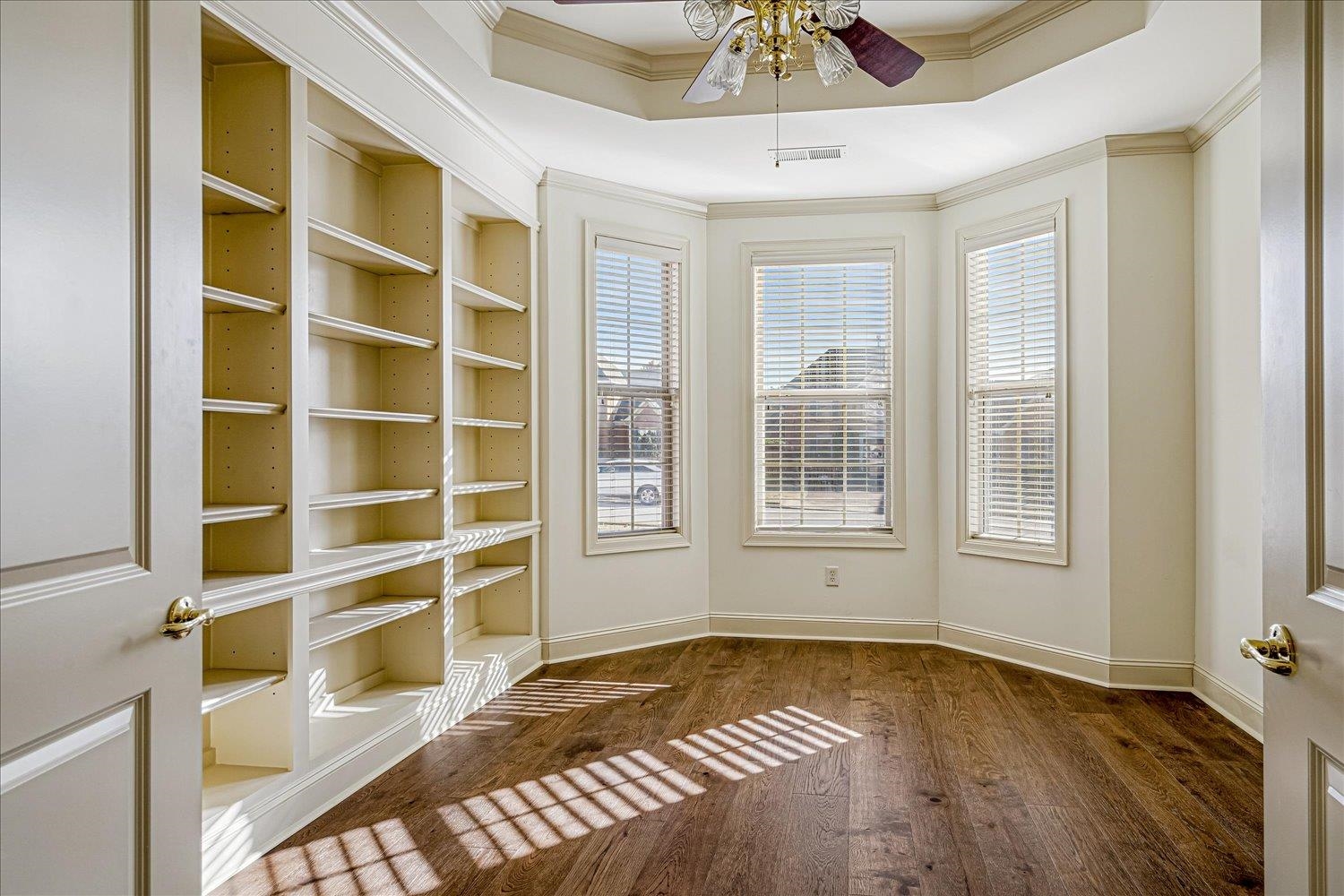 9178 Wilderridge Lane Memphis, TN 38018 - Photo 8 of 31 a view of an empty room with a window and wooden floor