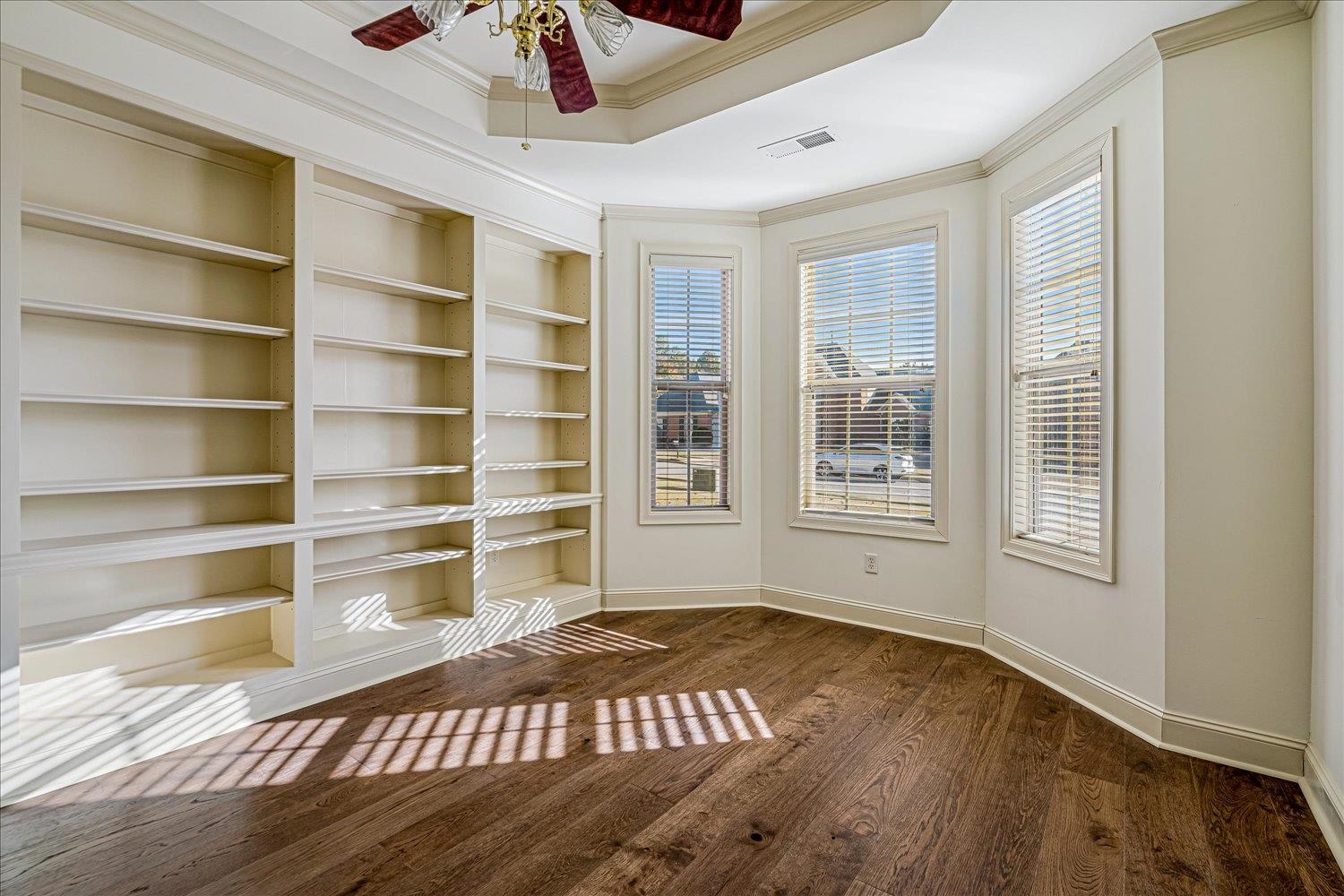 9178 Wilderridge Lane Memphis, TN 38018 - Photo 9 of 31 a view of an empty room with a window and wooden floor