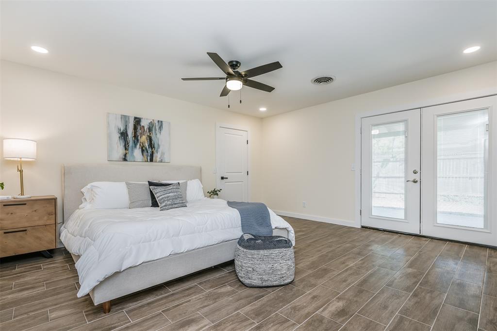 2006 Borger Plainview, TX 79072 - Photo 11 of 27 a spacious bedroom with a bed and a chandelier