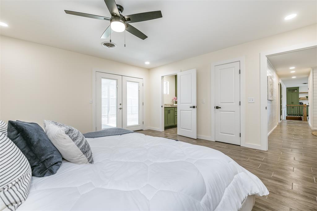 2006 Borger Plainview, TX 79072 - Photo 12 of 27 a spacious bedroom with a bed and a chandelier
