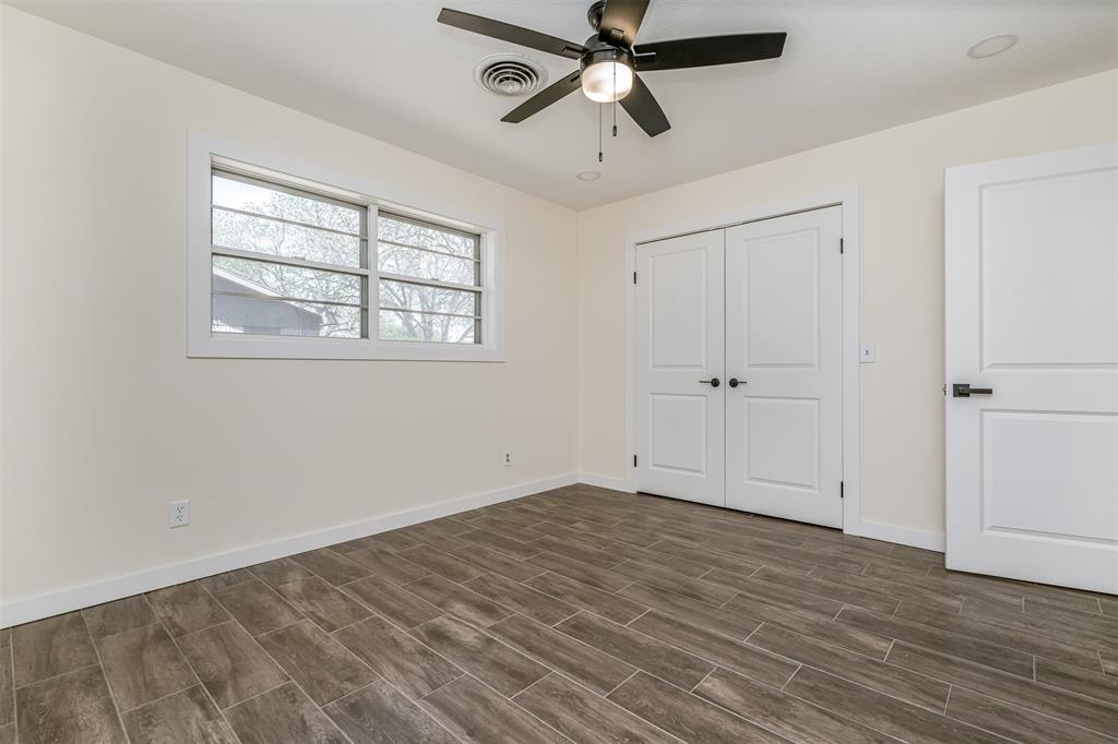 2006 Borger Plainview, TX 79072 - Photo 16 of 27 wooden floor in an empty room with a window