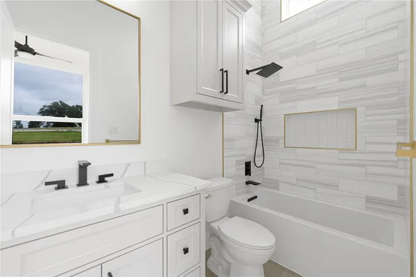 a bathroom with a sink a toilet and bathtub