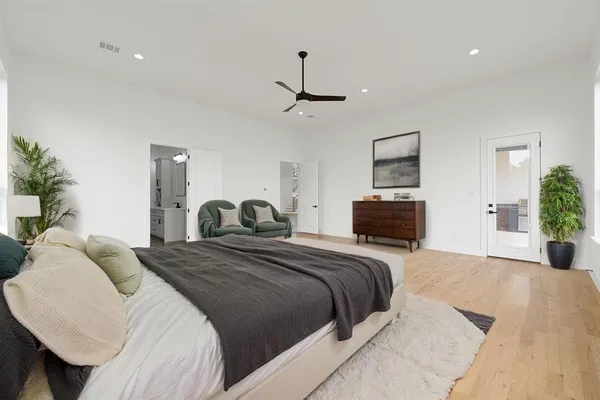 a bedroom with a bed and ceiling fan