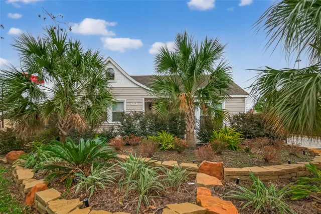 a house with a plant in front of it